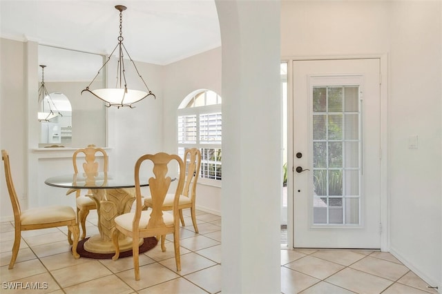 tiled dining room with ornamental molding