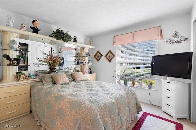 bedroom featuring light colored carpet