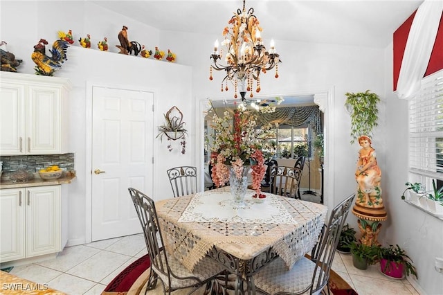 tiled dining area featuring an inviting chandelier