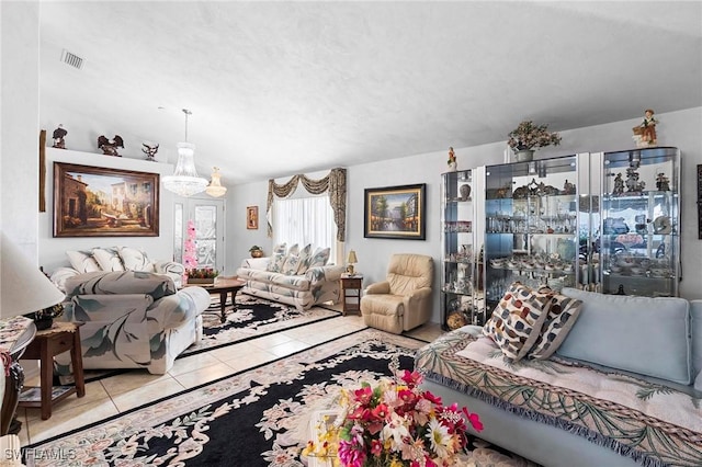 tiled living room with an inviting chandelier