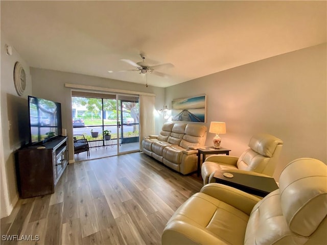 living room featuring ceiling fan and wood-type flooring