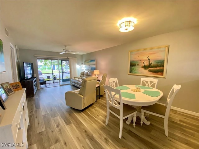 dining space featuring ceiling fan and light hardwood / wood-style floors