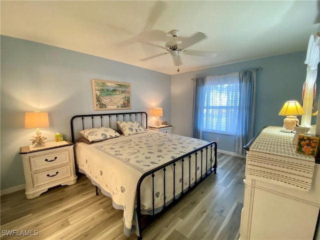 bedroom featuring light wood-type flooring and ceiling fan