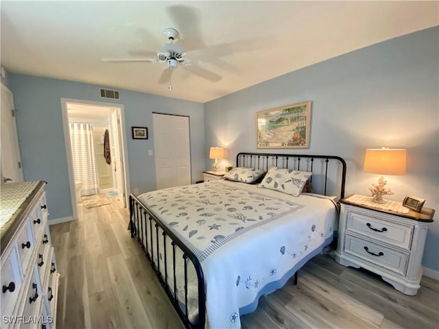 bedroom with light hardwood / wood-style floors, a closet, and ceiling fan