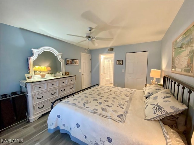 bedroom featuring dark wood-type flooring, ceiling fan, and a closet