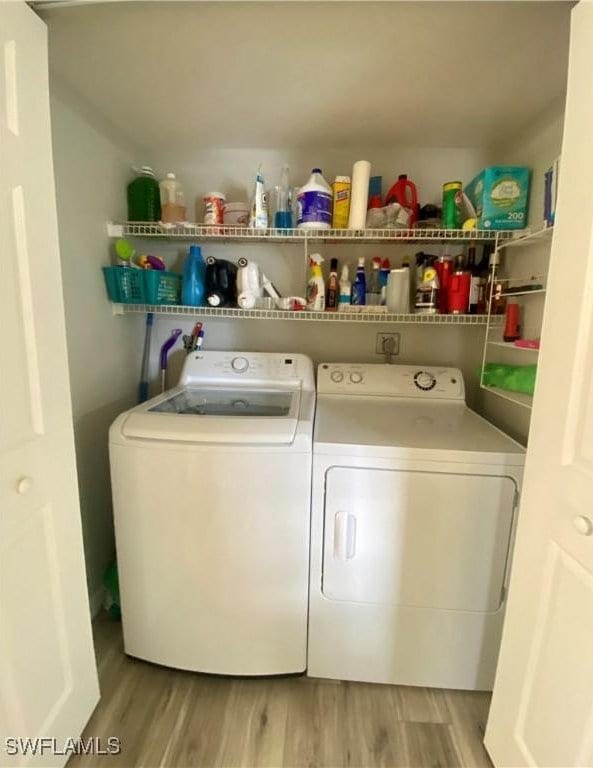 laundry area featuring light hardwood / wood-style floors and washer and dryer