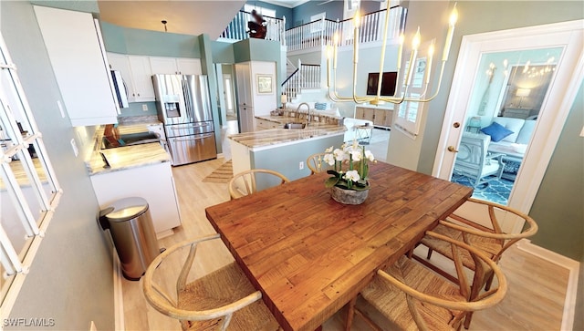 dining room with light hardwood / wood-style floors and sink