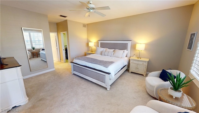 bedroom with ceiling fan and light colored carpet