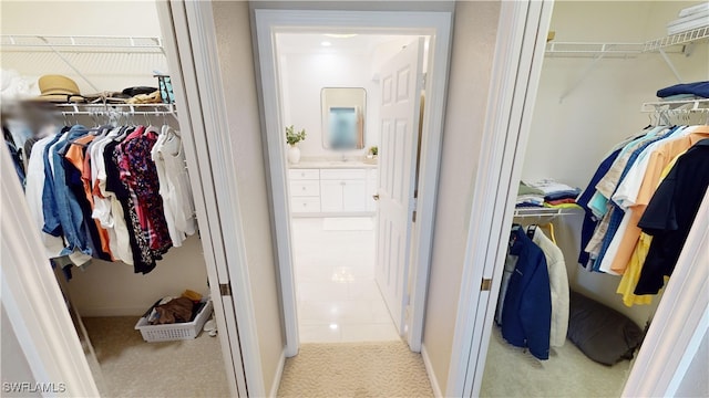 spacious closet with sink and light carpet