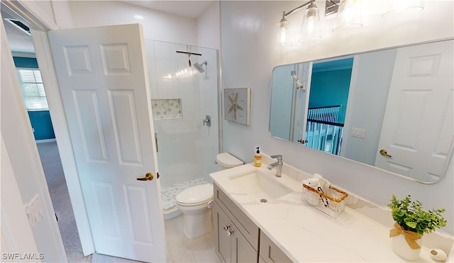 bathroom featuring a tile shower, vanity, and toilet