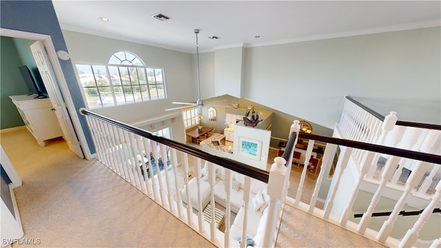 staircase featuring carpet and ornamental molding