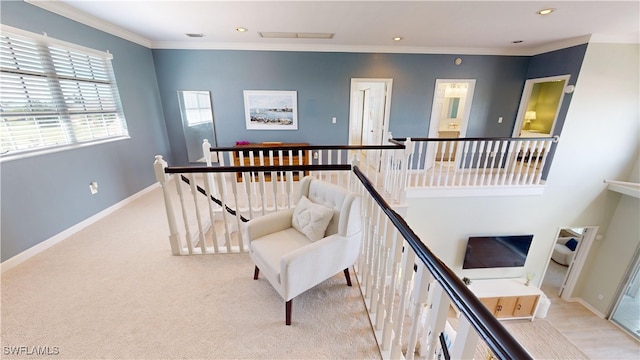 staircase with crown molding and carpet