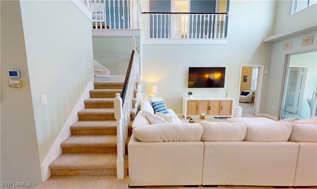 living room featuring a towering ceiling