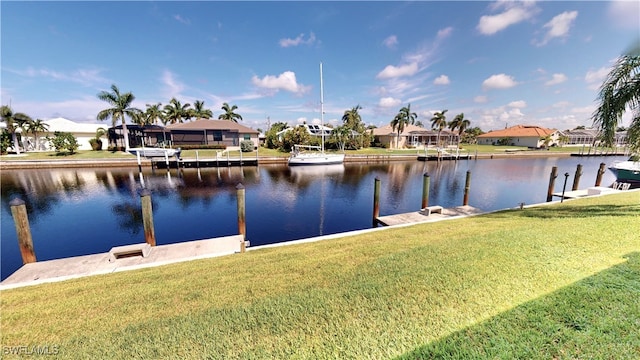 dock area featuring a lawn and a water view