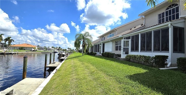 view of dock featuring a yard and a water view