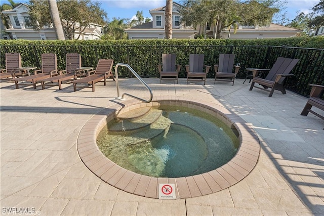 view of pool with a patio and a hot tub