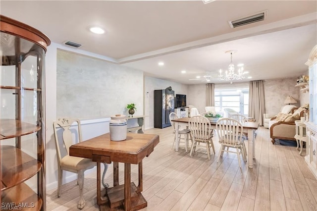 dining room featuring light hardwood / wood-style floors and an inviting chandelier