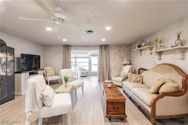 living room with light wood-type flooring and ceiling fan