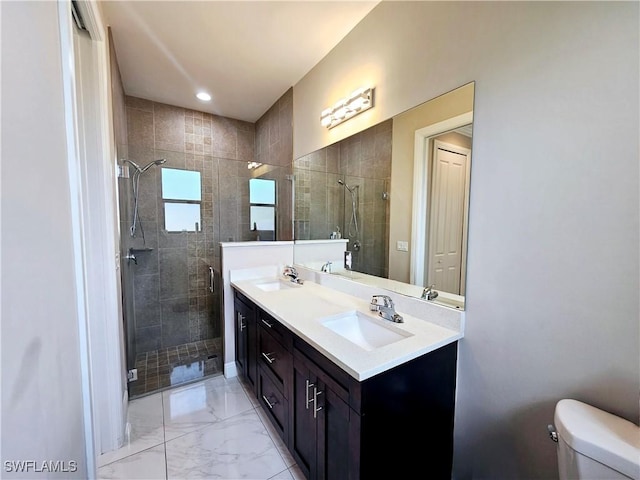 bathroom featuring vanity, toilet, and an enclosed shower