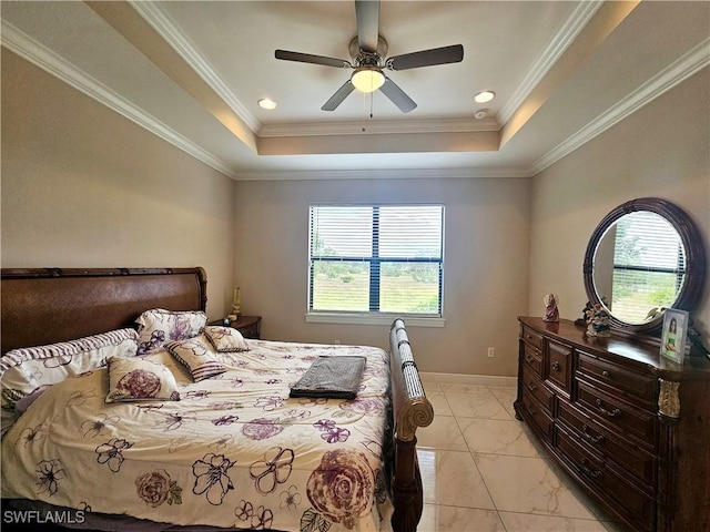 bedroom featuring multiple windows, a tray ceiling, and ceiling fan