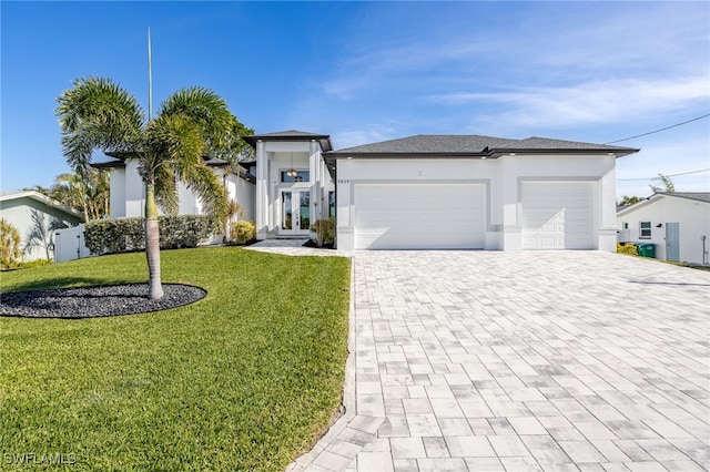 view of front of property with a garage and a front yard