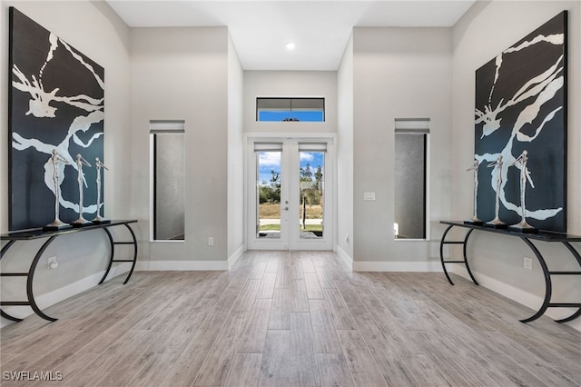 entrance foyer featuring french doors and a towering ceiling