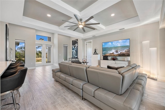 living room with beam ceiling, french doors, ceiling fan, and coffered ceiling