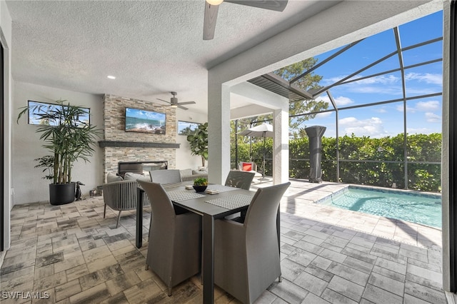 exterior space with ceiling fan and an outdoor stone fireplace