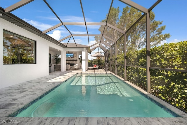 view of pool featuring glass enclosure, a fireplace, and a patio