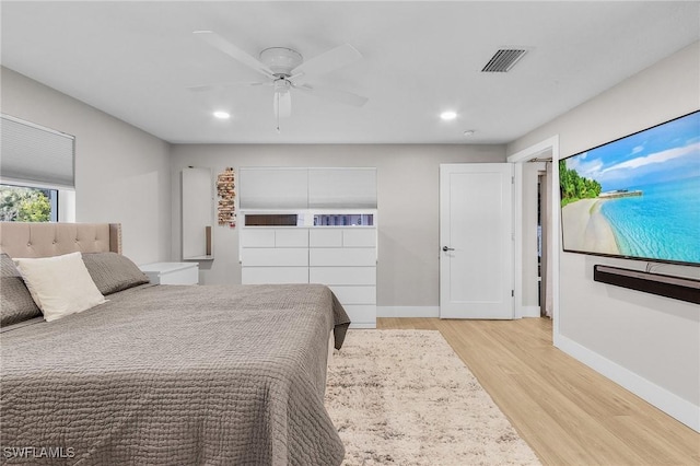 bedroom with light hardwood / wood-style floors and ceiling fan