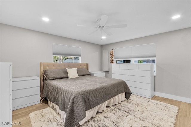 bedroom with light hardwood / wood-style flooring and ceiling fan