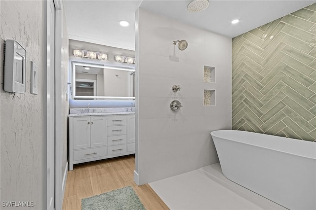 bathroom featuring hardwood / wood-style floors, vanity, and separate shower and tub