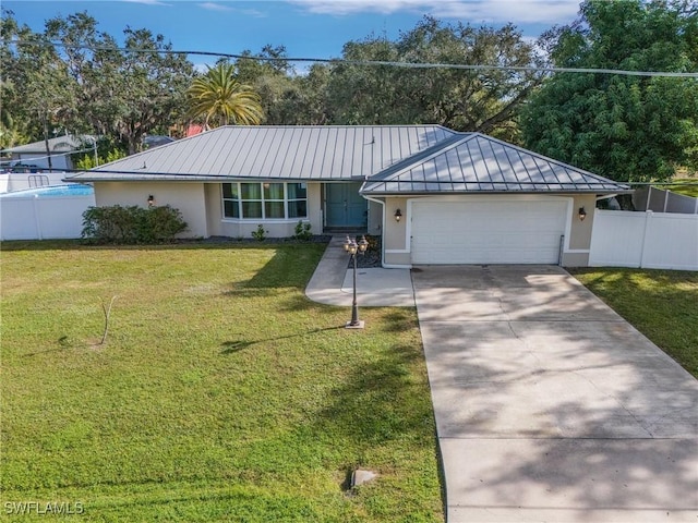 single story home featuring a garage and a front yard