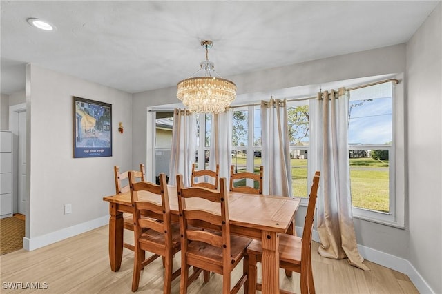 dining space with a chandelier and light hardwood / wood-style floors