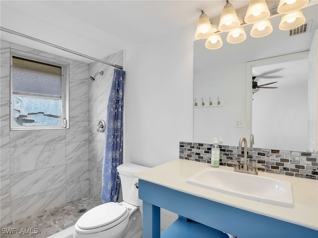 bathroom featuring vanity, a shower with shower curtain, decorative backsplash, ceiling fan, and toilet