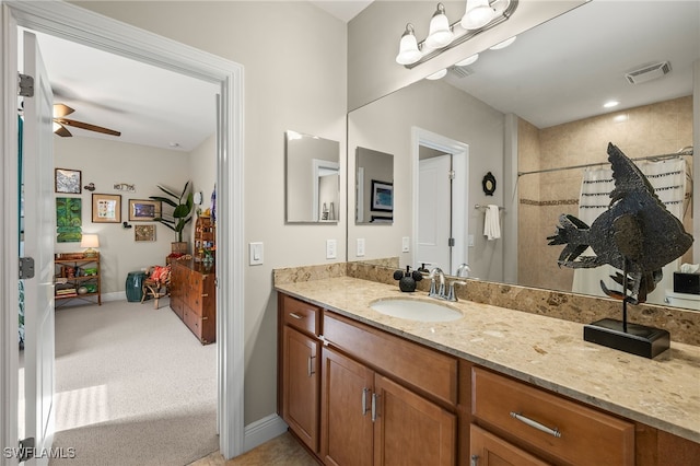 bathroom with curtained shower, ceiling fan, and vanity