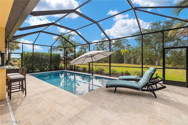 view of swimming pool with glass enclosure, a bar, and a patio