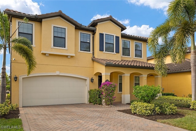 mediterranean / spanish-style home with a garage