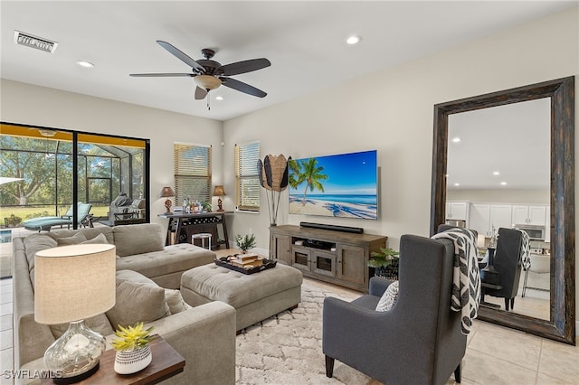 living room featuring ceiling fan and light tile patterned floors