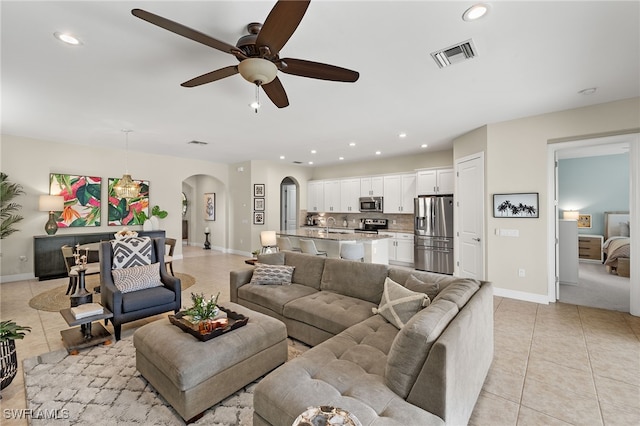 tiled living room featuring ceiling fan