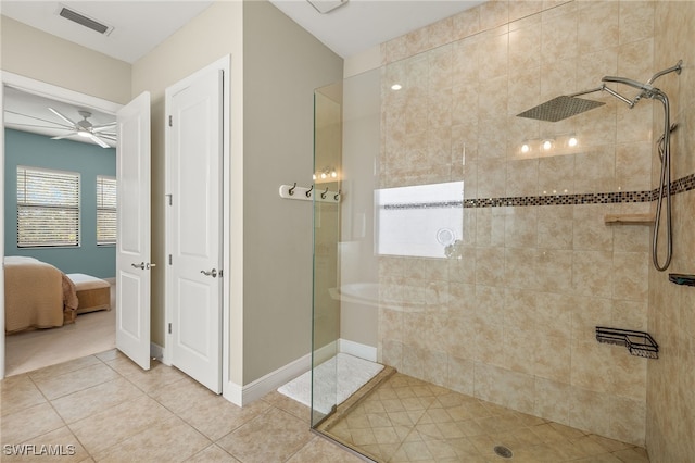 bathroom with a tile shower, tile patterned floors, and ceiling fan