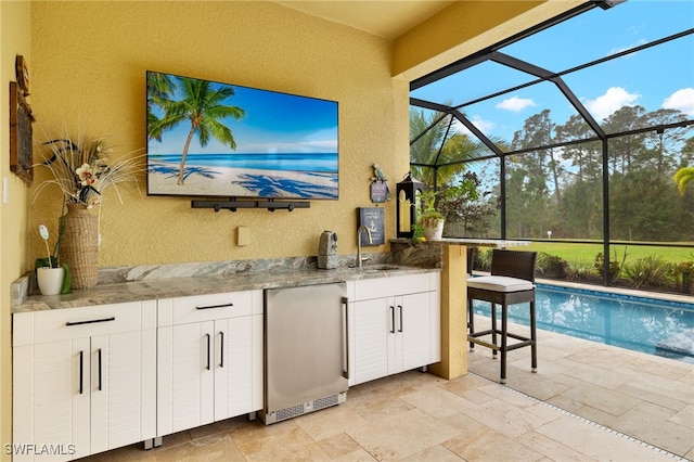 exterior space with a lanai and a wet bar