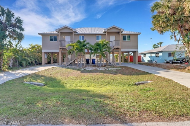 view of front of house with a front lawn and a carport