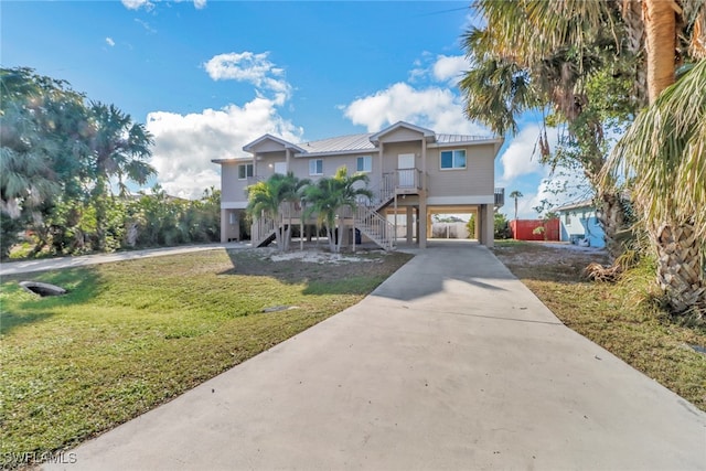 view of front facade with a front lawn and a carport