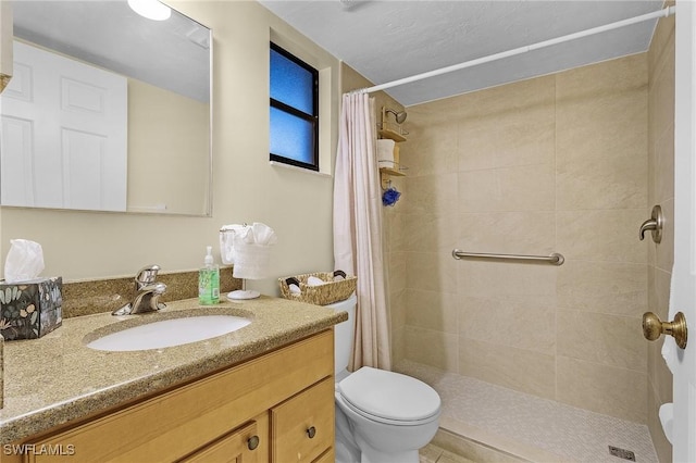 bathroom with vanity, toilet, and walk in shower