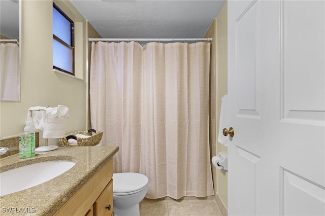 bathroom featuring tile patterned flooring, vanity, curtained shower, and toilet