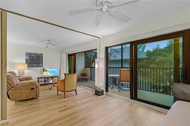 sunroom / solarium featuring ceiling fan