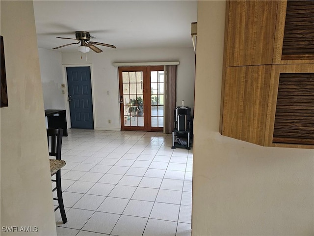 interior space with ceiling fan, light tile patterned floors, and french doors