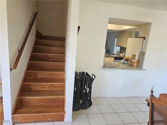 staircase featuring tile patterned flooring