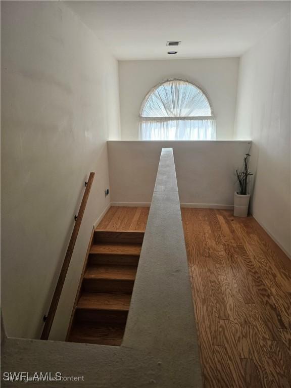 stairs featuring hardwood / wood-style flooring